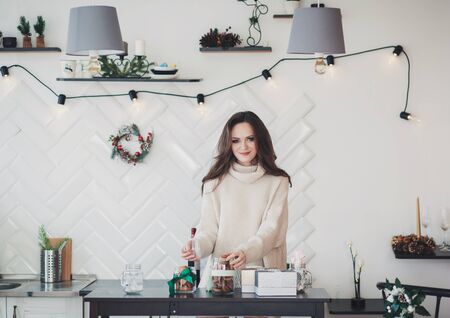 beautiful woman with cookies in the kitchen is in the new year holidaysの写真素材