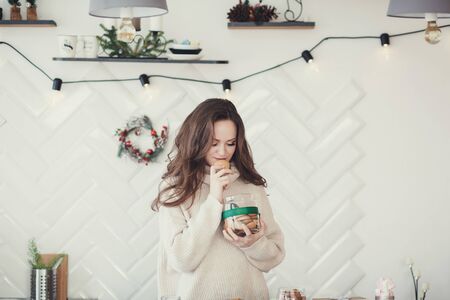 festive mood. happy woman with sweets standing in the kitchenの写真素材