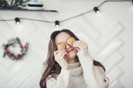 funny woman holding cookie hearts near her eyes. Valentine's dayの写真素材