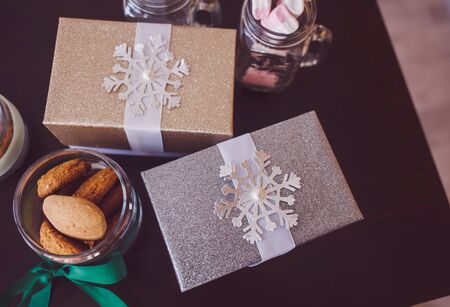 Christmas gifts and cookies on the table. festive moodの写真素材