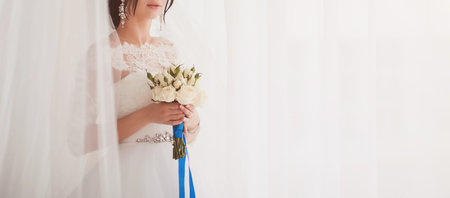 Brides wedding bouquet roses in women's hands. copy spaceの写真素材