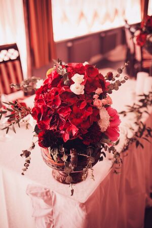 red bouquet with flowers on the wedding tableの写真素材