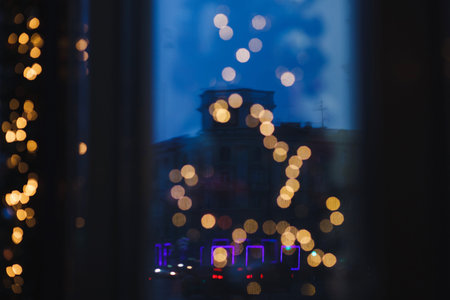 defocused Christmas lights on the background of night city