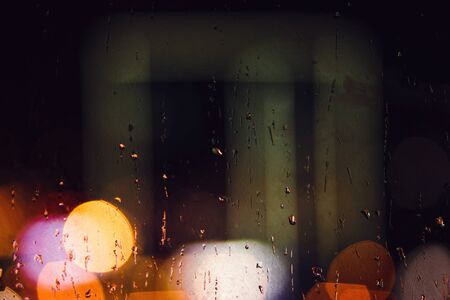Raindrops on the window at night, rain backgroundの写真素材