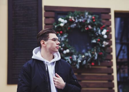 stylish young man posing in a black jacketの写真素材