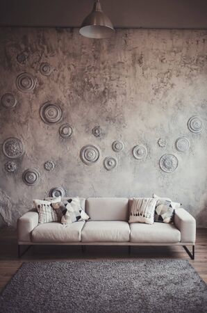 sofa with pillows in living room interior with lamp. Real photoの写真素材