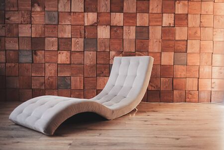 stylish modern chair in the interior and wooden wallの写真素材