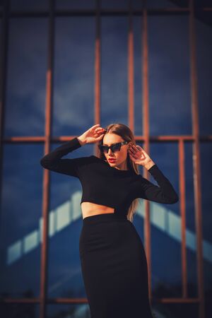 Beautiful young business woman wearing black dress.の写真素材