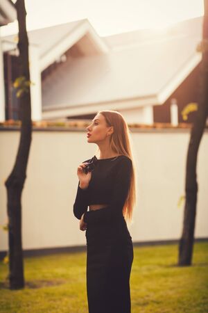 Young successful woman in business dress standing on the background of the hotelの写真素材