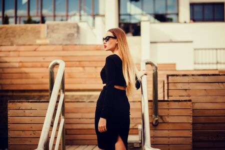 Portrait of a young girl in the city. outdoors. looking awayの写真素材