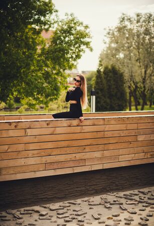 Young beautiful model in sunglasses posing in the park outdoors.の写真素材