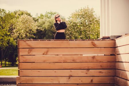 stylish young woman posing on a sunny summer day. looking at the cameraの写真素材