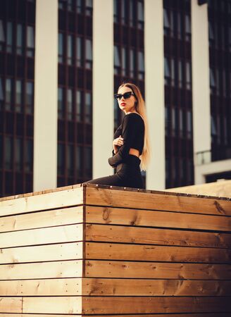 Portrait of a business woman in sunglasses near the office building outdoorsの写真素材
