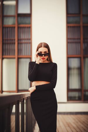 Portrait of a successful and confident woman in sunglasses outdoors. looking at the cameraの写真素材