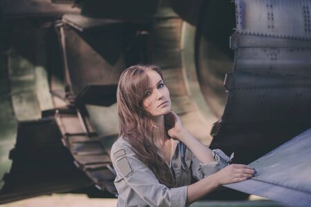 Beautiful woman with curly hair and military uniformの写真素材