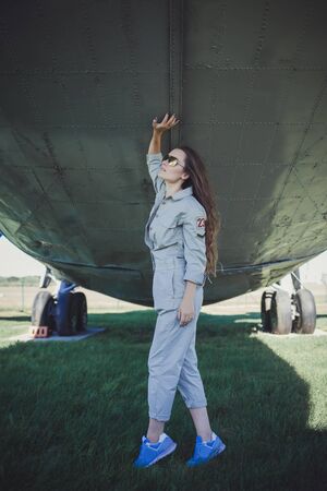 full-length portrait of a beautiful woman in sneakers and sunglassesの写真素材