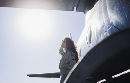 trendy stylish woman in sunglasses posing over sky backgroundの写真素材