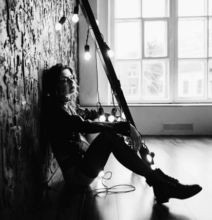 black and white portrait melancholy woman in black leather jacketの写真素材