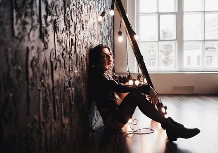 melancholy woman in black leather jacket portraitの写真素材