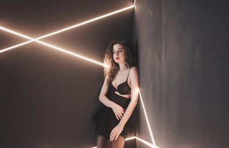 beautiful sexy lady in black bra and curly hair posing in the Studioの写真素材