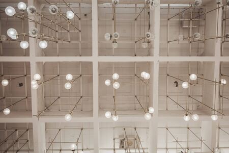 many light bulbs on the ceiling of the office spaceの写真素材