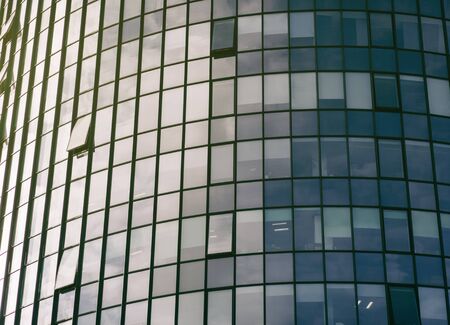 windows modern office building on sunsetの写真素材