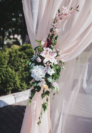 Arch for the wedding ceremony. Arch decorated and silvery cloth and flowersの写真素材