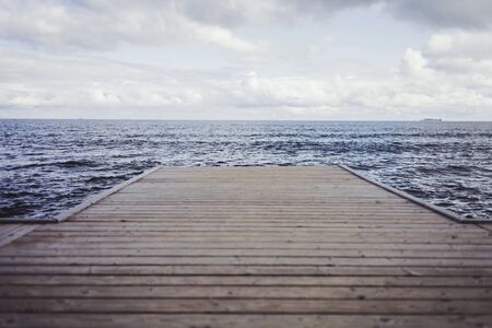 Wooden pier, sea and a blue sky. Beautiful background. Minimalismの写真素材