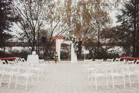 Wedding arch decorated with cloth and flowers outdoors. Beautiful wedding set upの写真素材