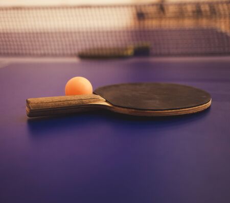 Tennis racket and ball on blue table, game conceptの写真素材