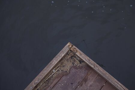 corner of a wooden pier on the background of the lakeの写真素材