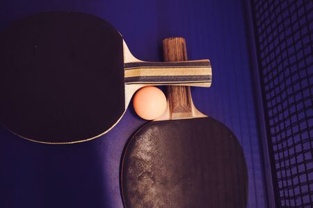Tennis rackets and ball on blue background. Sport concept.の写真素材