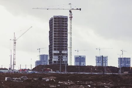 Construction site with cranes of a modern apartment building.の写真素材