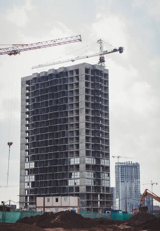 construction of a concrete house, construction is underway, cranes are workingの写真素材