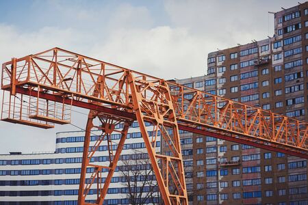 large yellow crane on the background of a new house under constructionの写真素材
