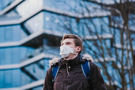 Man wearing protective mask against transmissible infectious diseases and as protection against the flu in city. New coronavirus 2019-nCoVの写真素材