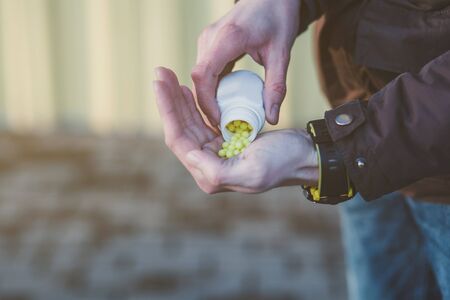 yellow pills in hand. prevention from coronavirus. protection of immunity. covid-19の写真素材
