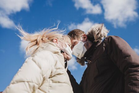 Couple with disposable masks outdoors. Virus protectionの写真素材