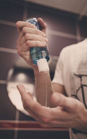 Man washing hands with alcohol gel or antibacterial soap sanitizer. prevent the spread of germs and bacteria and avoid infections corona virusの写真素材