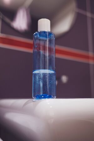 Blue plastic bottle with liquid soap in bathroomの写真素材