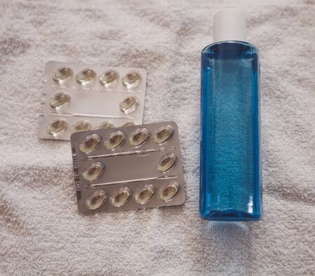 blue bottle of antibacterial soap and tablets. virus protectionの写真素材