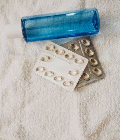 plastic with antibacterial liquid soap and antibiotics on a white towelの写真素材