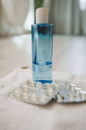 blue plastic bottle with antibacterial soap and antibiotic tablets. quarantineの写真素材
