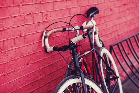 two vintage bicycle parking against colorful wall in cityの写真素材