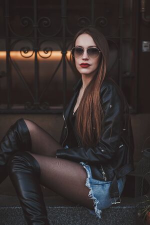 Fashion photo. Street style fashion woman in sunglasses. Professional model posing in cityの写真素材