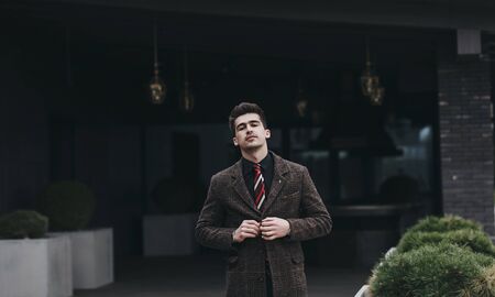 Elegant young handsome man in autumn coat. fashion portrait.の写真素材