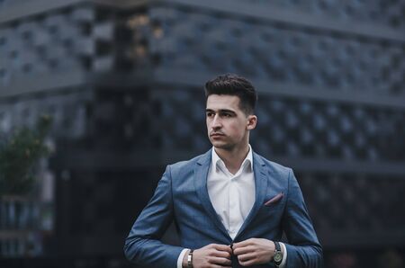 Handsome confident man in suit looking awayの写真素材