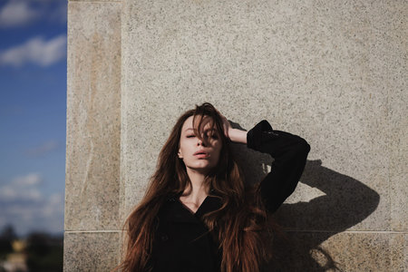 Close up portrait of elegant luxurious woman in trendy coat.