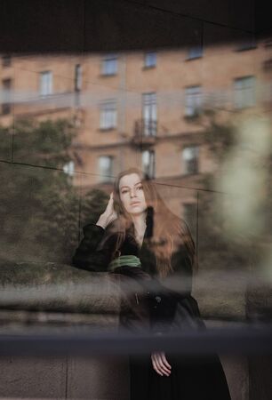 portrait of a young beautiful fashionable woman wearing stylish coat. Female fashion, beauty and advertisement conceptの写真素材