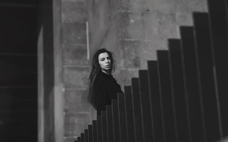 Trendy woman in coat. Black and white portrait